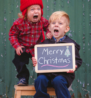 little girl bawling while her brother is smiling