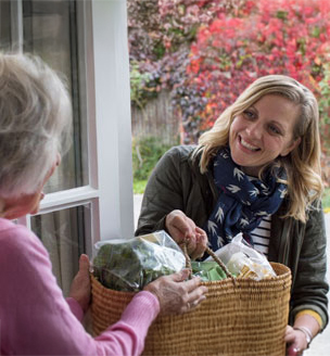 Woman delivering package to elderly