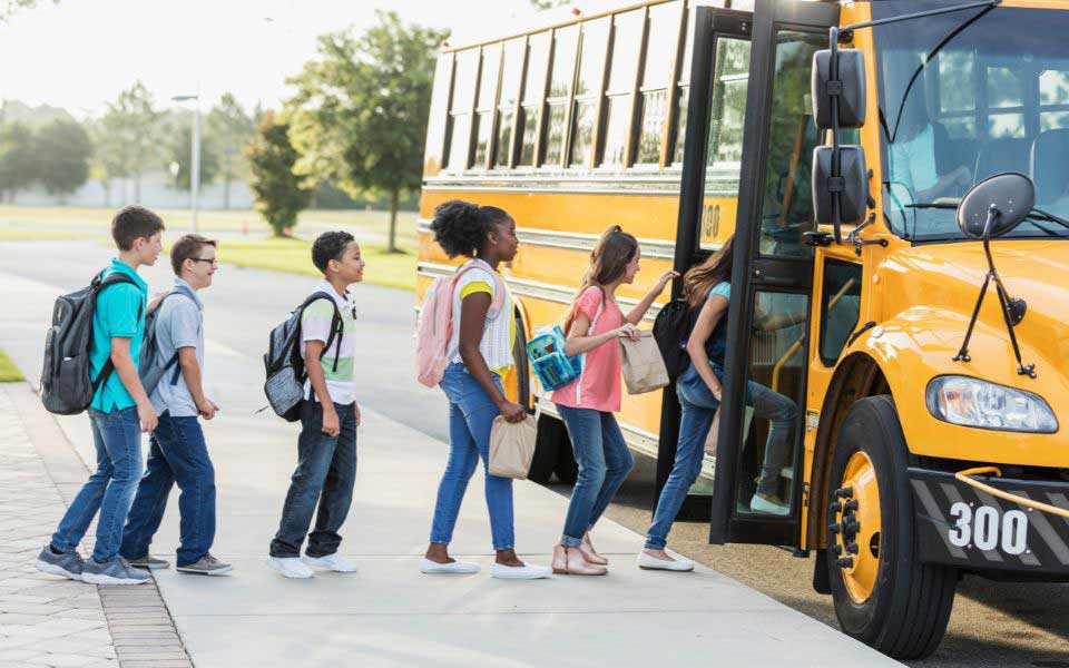 Students getting onboard a school bus